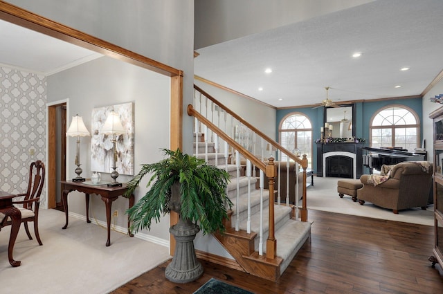 304 Reavley Dr, Lamar, MO 64759 - stairs featuring hardwood / wood-style floors, a fireplace, baseboards, and ceiling fan