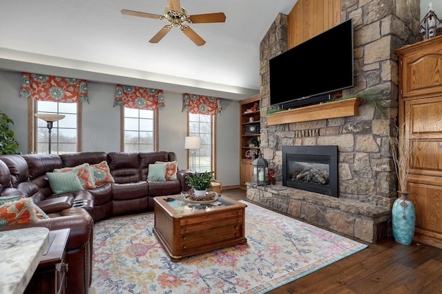 304 Reavley Dr, Lamar, MO 64759 - living area featuring built in shelves, a fireplace, a ceiling fan, and wood finished floors