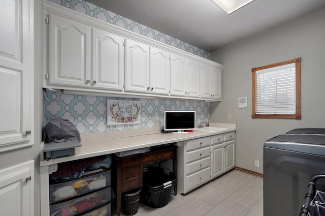 304 Reavley Dr, Lamar, MO 64759 - laundry area featuring washer and clothes dryer, cabinet space, baseboards, and a sink