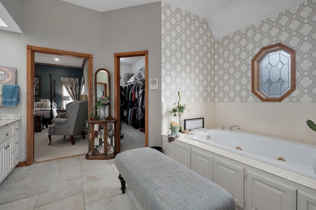 304 Reavley Dr, Lamar, MO 64759 - ensuite bathroom featuring connected bathroom, a jetted tub, a spacious closet, and wallpapered walls