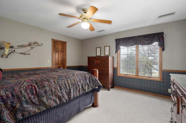 304 Reavley Dr, Lamar, MO 64759 - bedroom featuring a wainscoted wall, light colored carpet, visible vents, and ceiling fan