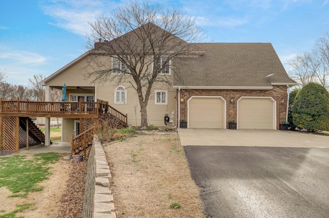 304 Reavley Dr, Lamar, MO 64759 - view of front of property featuring a ceiling fan, aphalt driveway, an attached garage, brick siding, and stairs