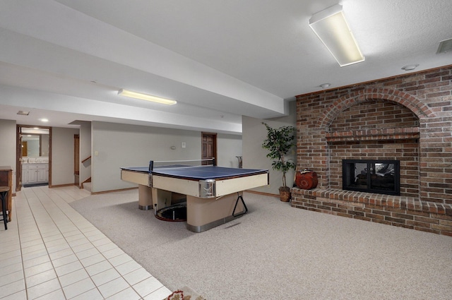 304 Reavley Dr, Lamar, MO 64759 - game room with baseboards, visible vents, tile patterned flooring, a brick fireplace, and carpet flooring