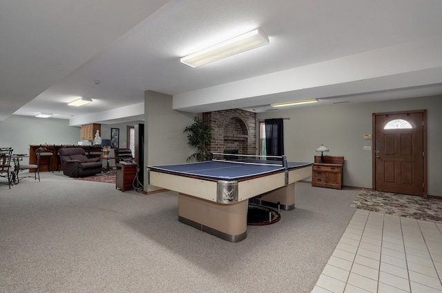 304 Reavley Dr, Lamar, MO 64759 - rec room featuring light carpet, light tile patterned floors, and a brick fireplace
