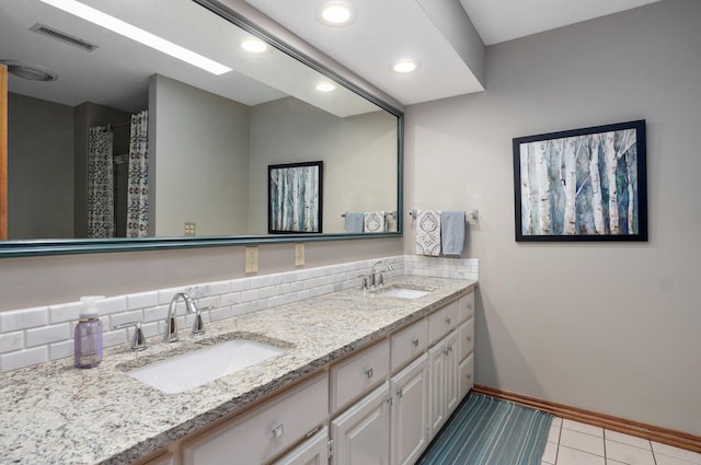 304 Reavley Dr, Lamar, MO 64759 - bathroom featuring tile patterned flooring, double vanity, visible vents, and a sink