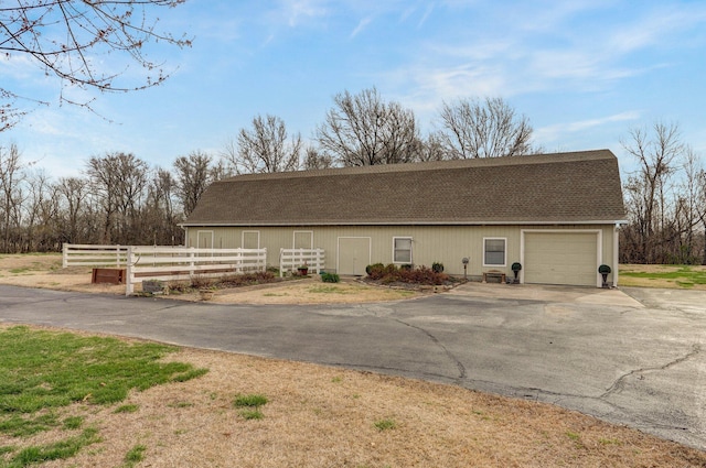 304 Reavley Dr, Lamar, MO 64759 - garage featuring aphalt driveway and fence
