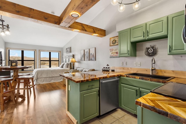kitchen with vaulted ceiling with beams, butcher block countertops, open floor plan, dishwasher, and a sink