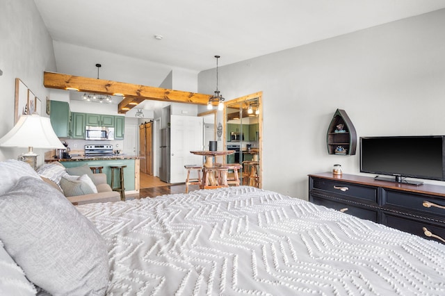 bedroom featuring lofted ceiling and freestanding refrigerator