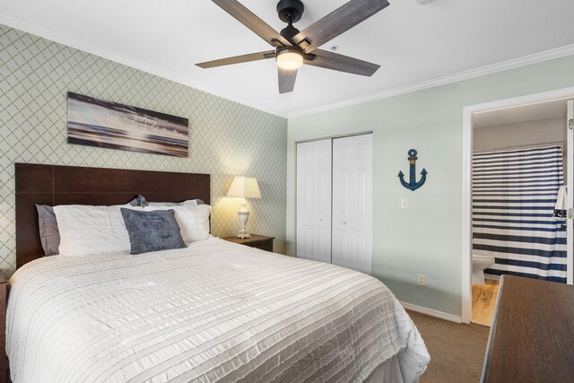 carpeted bedroom with a closet, baseboards, crown molding, and wallpapered walls