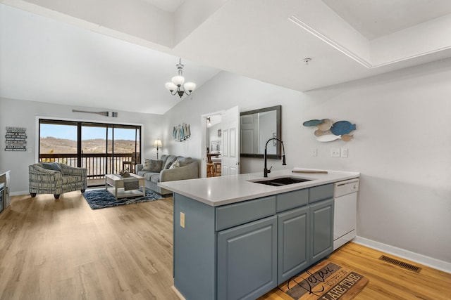 kitchen with visible vents, light wood-style flooring, a sink, white dishwasher, and light countertops