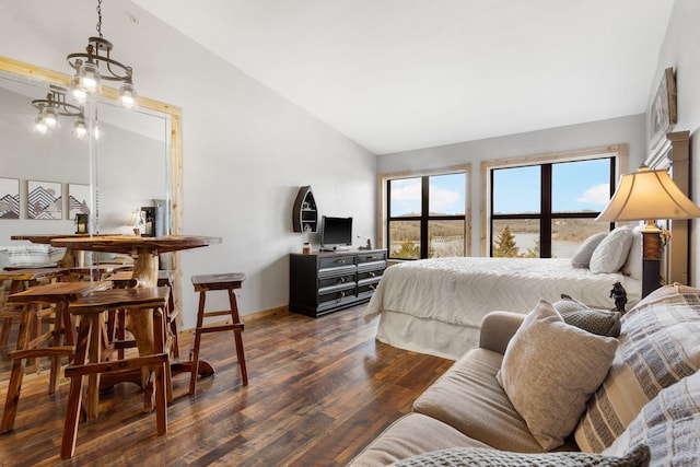 bedroom with dark wood finished floors, high vaulted ceiling, and baseboards