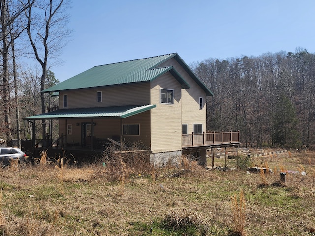 496 Timberline Rd, Willow Springs, MO 65793 - view of home's exterior with a wooded view, covered porch, and metal roof