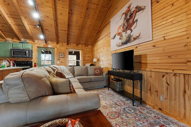 living room featuring wooden walls, beam ceiling, wooden ceiling, wood finished floors, and high vaulted ceiling