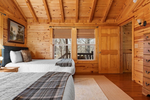 bedroom with wooden walls, wooden ceiling, lofted ceiling with beams, and wood finished floors