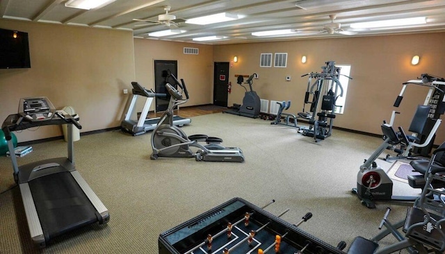 workout area with visible vents, baseboards, and ceiling fan