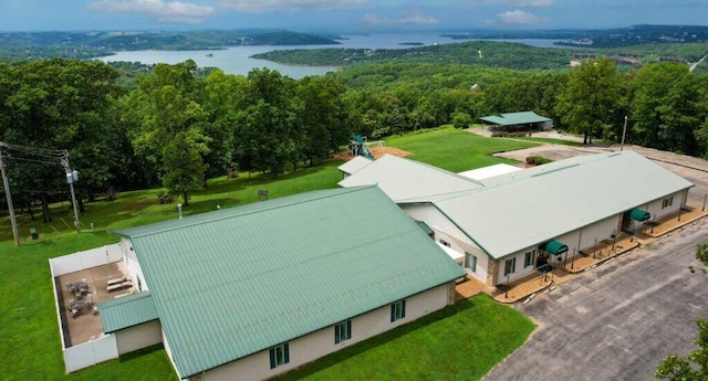 birds eye view of property with a wooded view and a water view