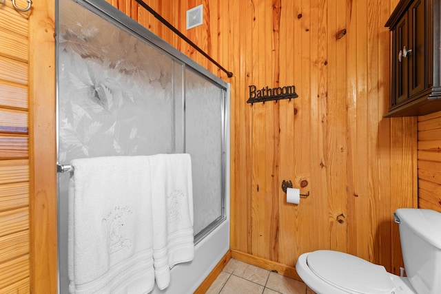 full bathroom with tile patterned flooring, wooden walls, toilet, and visible vents
