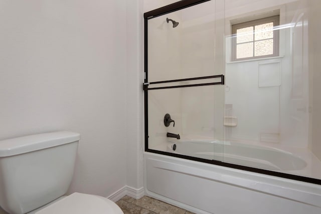 full bath with toilet, baseboards, and bath / shower combo with glass door