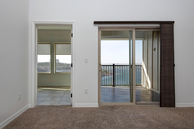 empty room with baseboards and carpet floors