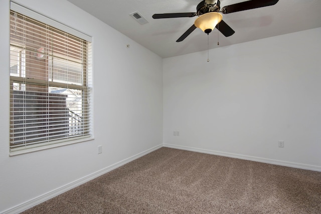 unfurnished room featuring visible vents, baseboards, a ceiling fan, and carpet flooring