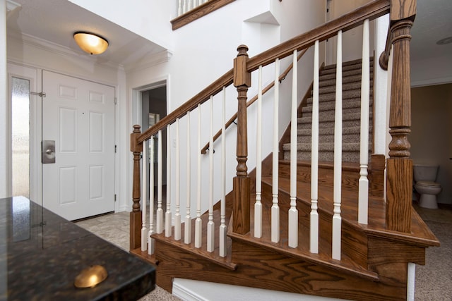 entryway with stairway and ornamental molding