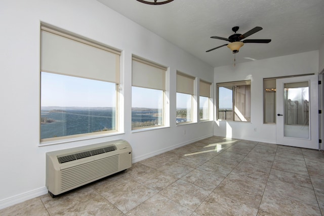 unfurnished sunroom with a wall unit AC