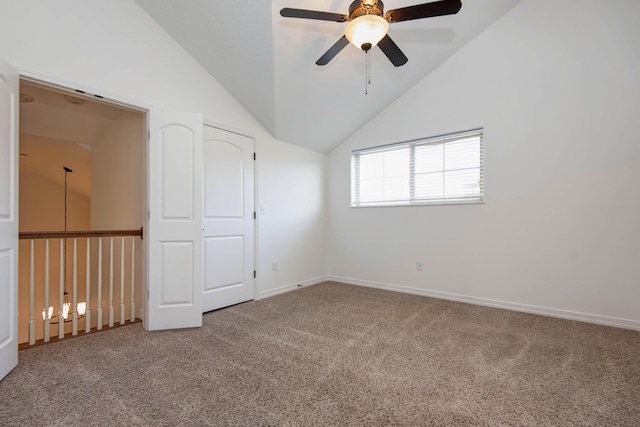 empty room featuring lofted ceiling, carpet flooring, a ceiling fan, and baseboards