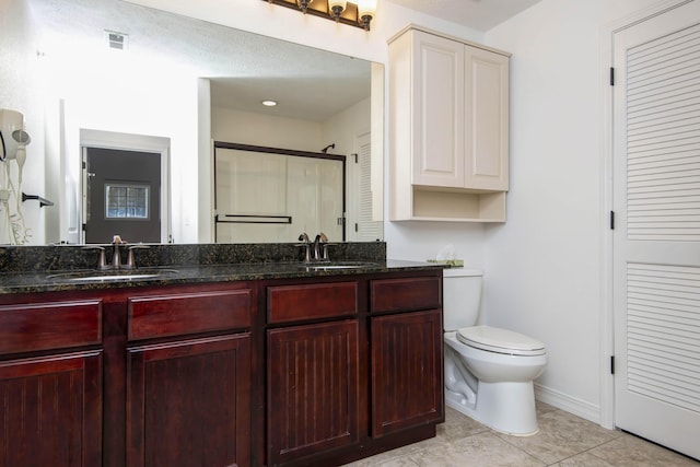 full bathroom with a stall shower, toilet, visible vents, and a sink