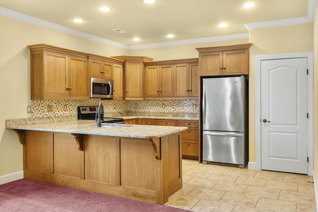 kitchen featuring light stone countertops, a peninsula, appliances with stainless steel finishes, a kitchen breakfast bar, and brown cabinets