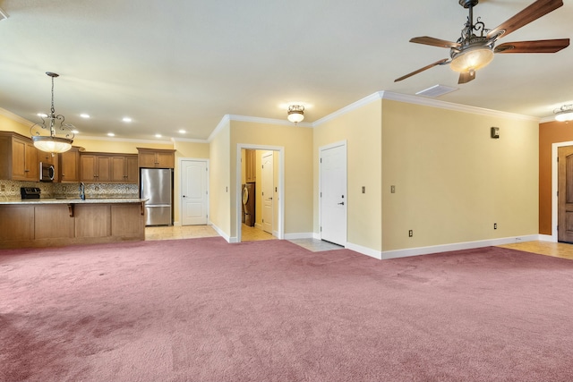 unfurnished living room featuring light colored carpet, baseboards, a ceiling fan, and ornamental molding