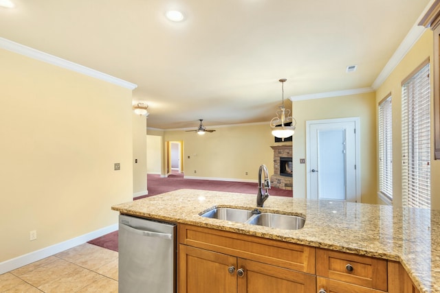kitchen with a sink, stainless steel dishwasher, ornamental molding, and a fireplace