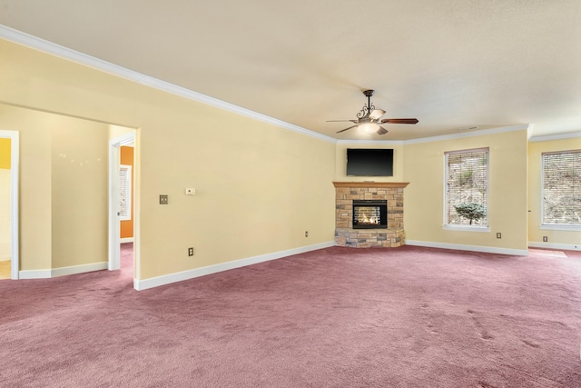 unfurnished living room with carpet floors, a stone fireplace, ornamental molding, and a ceiling fan