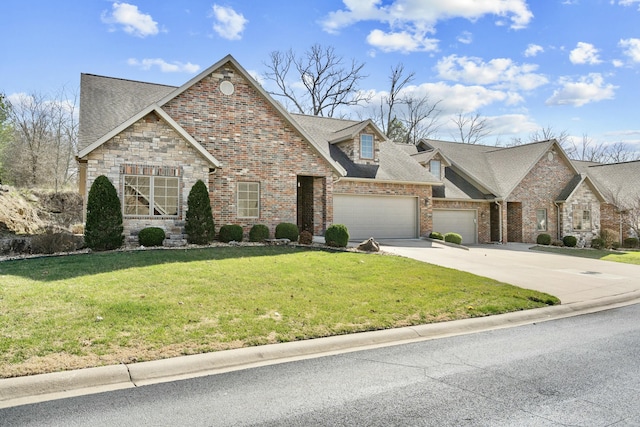 view of front of home featuring concrete driveway, a garage, a front yard, and roof with shingles