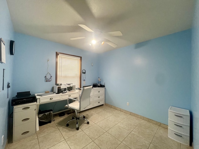 office area featuring baseboards, ceiling fan, and light tile patterned floors