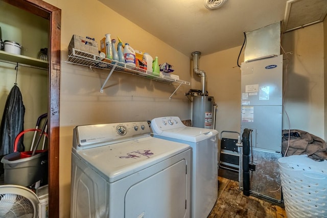 laundry room with water heater, dark wood-style floors, laundry area, and washer and clothes dryer