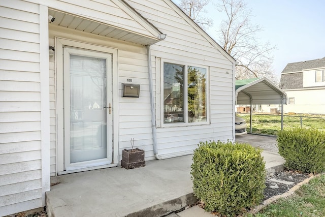 property entrance featuring a detached carport