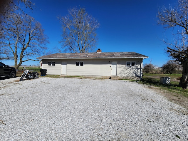 1622 W Fairview Ave, Carthage, MO 64836 - rear view of house with a chimney and driveway