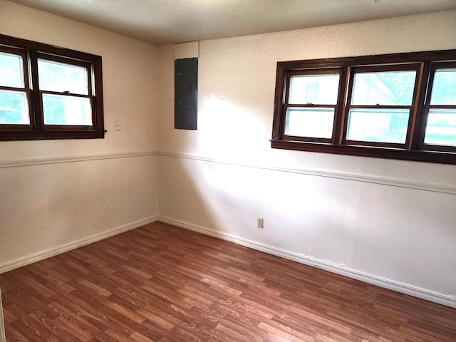 1622 W Fairview Ave, Carthage, MO 64836 - spare room with electric panel, wood finished floors, and healthy amount of natural light