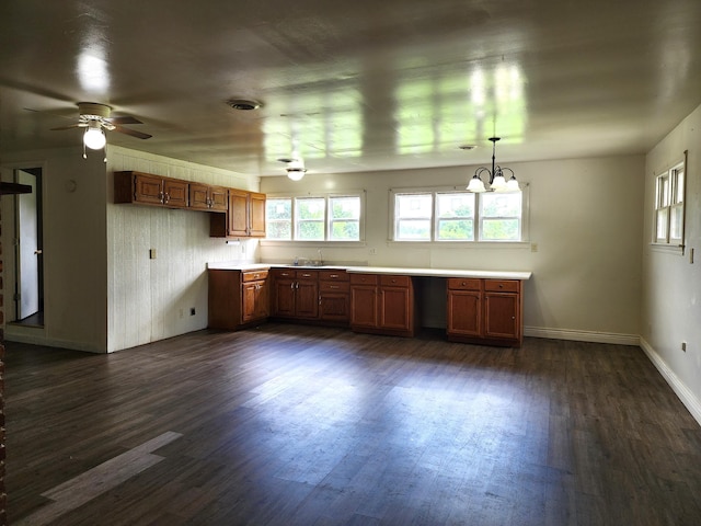 1622 W Fairview Ave, Carthage, MO 64836 - kitchen featuring plenty of natural light, dark wood-style flooring, baseboards, and brown cabinets