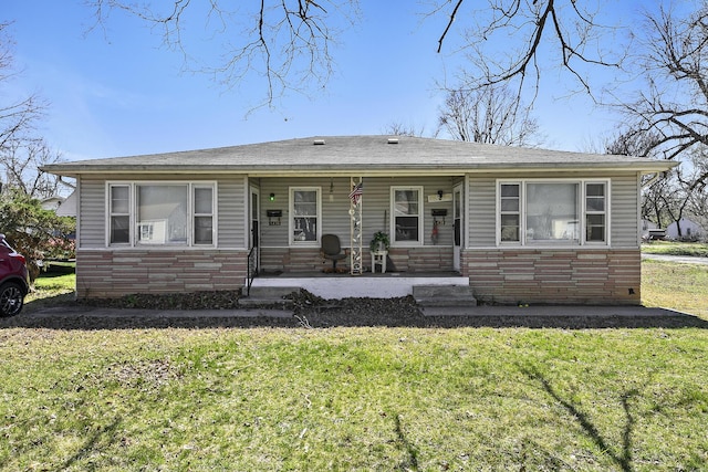 view of front of house featuring stone siding, a front lawn, and entry steps