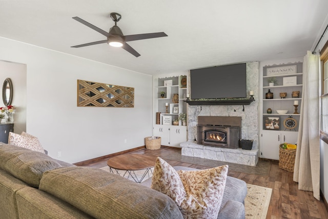 living area featuring built in features, baseboards, a ceiling fan, and wood finished floors