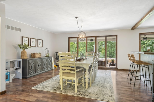 dining space with a chandelier, dark wood-type flooring, visible vents, and a healthy amount of sunlight
