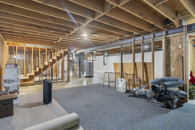 unfinished basement with stairway and water heater