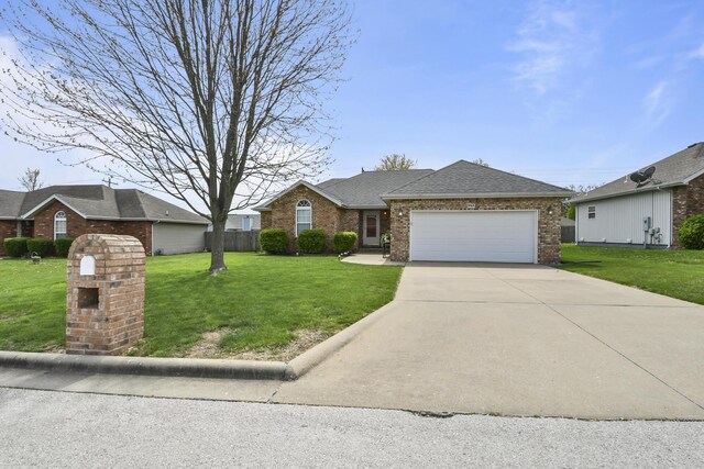 ranch-style house featuring an attached garage, concrete driveway, a front lawn, and brick siding