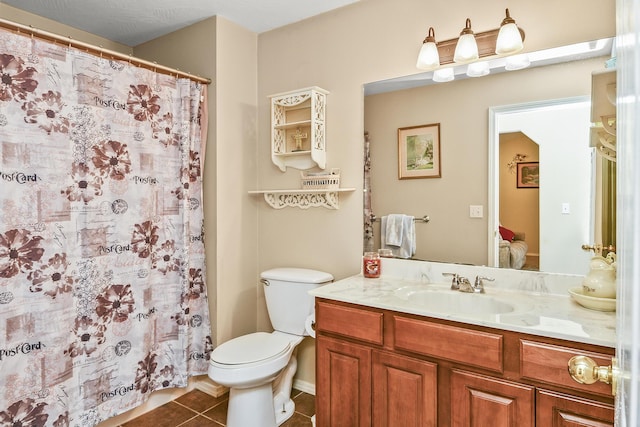bathroom with toilet, curtained shower, tile patterned flooring, and vanity