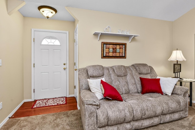 carpeted living area featuring baseboards