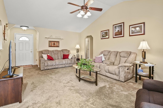 living area featuring baseboards, arched walkways, ceiling fan, carpet flooring, and lofted ceiling