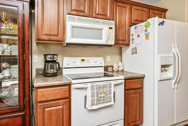 kitchen with brown cabinets and white appliances
