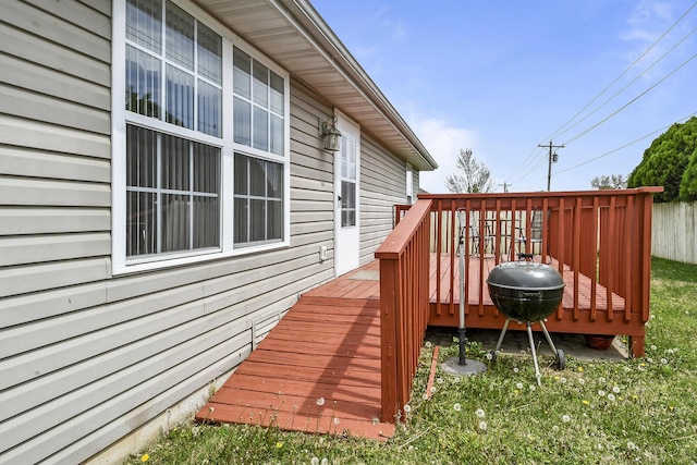 wooden terrace featuring area for grilling and fence