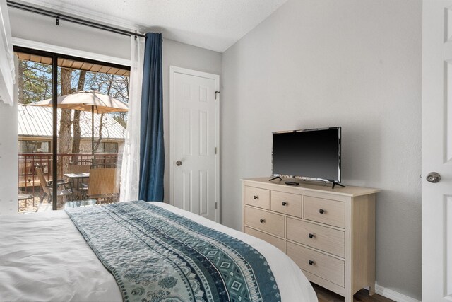 235 Ozark Mountain Resort Dr Unit 47, Kimberling City, MO 65686 - bedroom featuring a textured ceiling, baseboards, and lofted ceiling